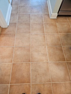 After — same tile floor with clean, light grout lines using Drop n Go