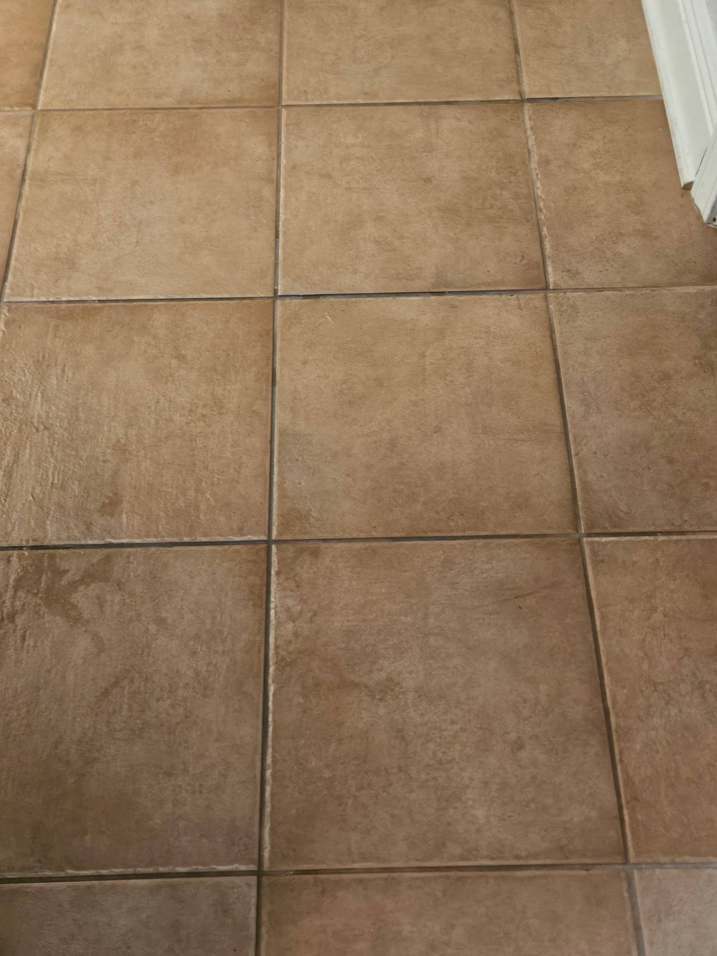 Before — tile floor with darkened grout and surface buildup from inconsistent mopping